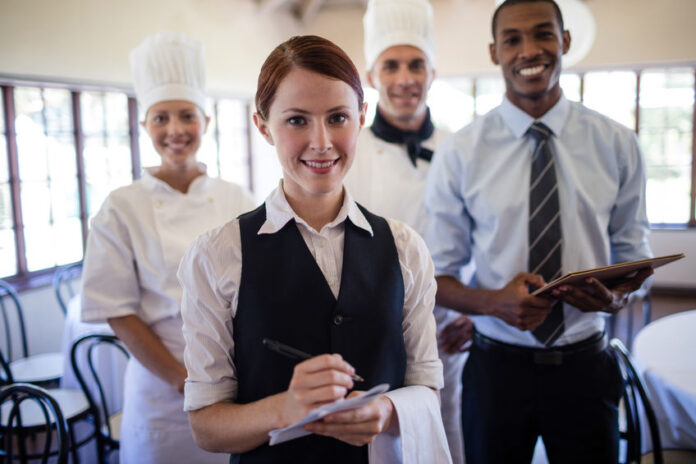 Group of hotel staffs standing together in hotel